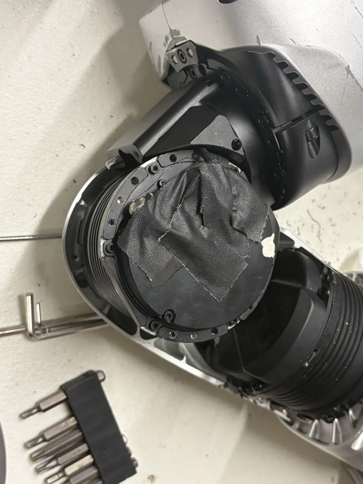 Hip actuator face covered in black fabric tape before peeling
