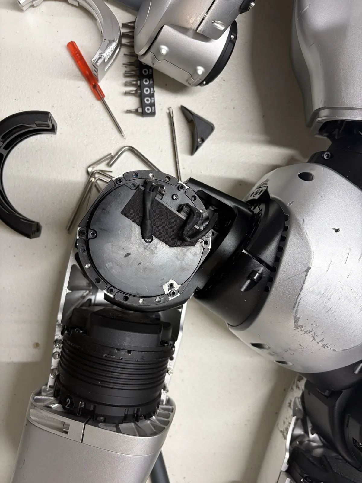 Hip actuator face with tape removed showing two wire terminations and the driver board