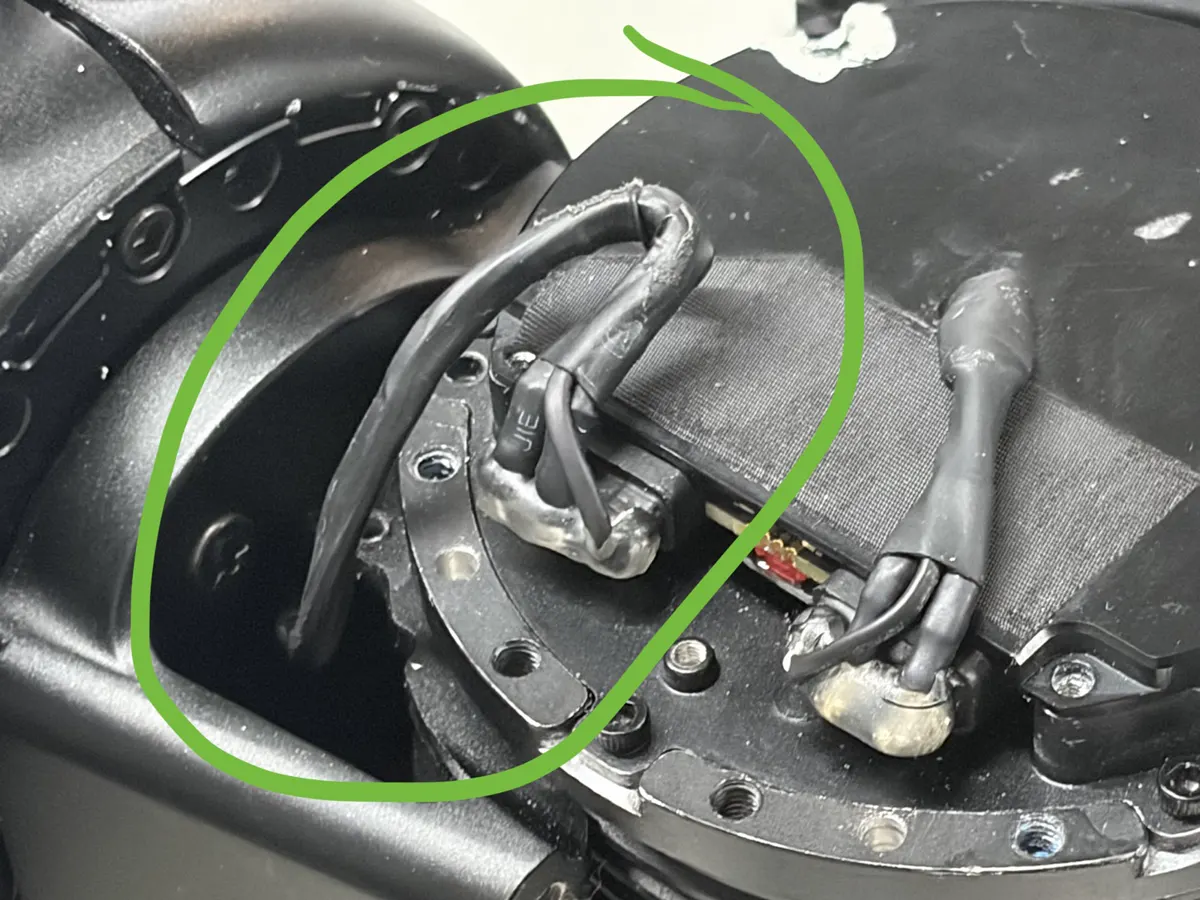 Close up of the kinked comm lead at the hip entry, circled in green marker